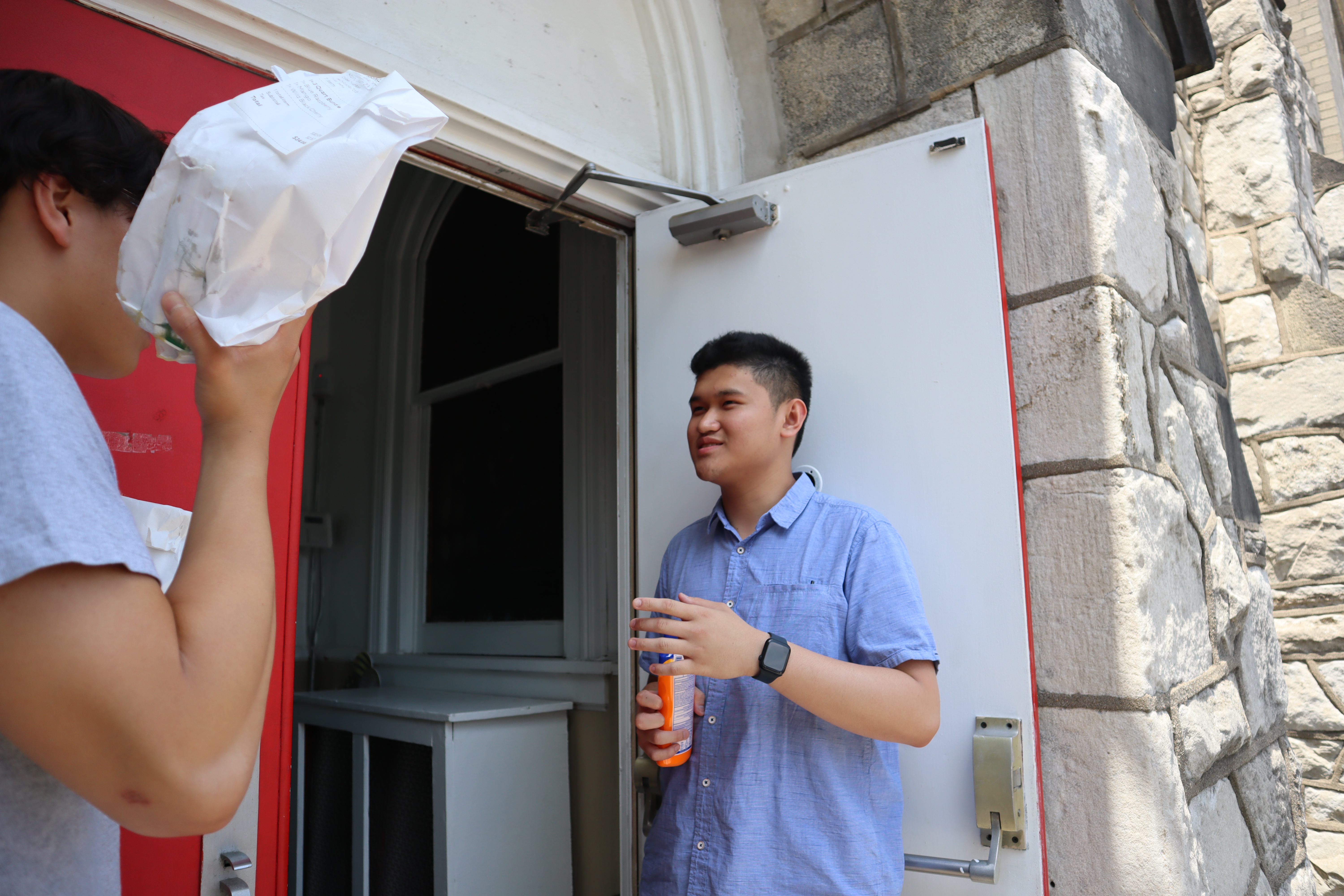 a young man speaks outside a church door