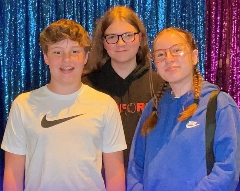 Max Bennett, Dane Yoder and Roslyn Shenk, members of the youth group at Toledo (Ohio) Mennonite Church, gather for a photo.
