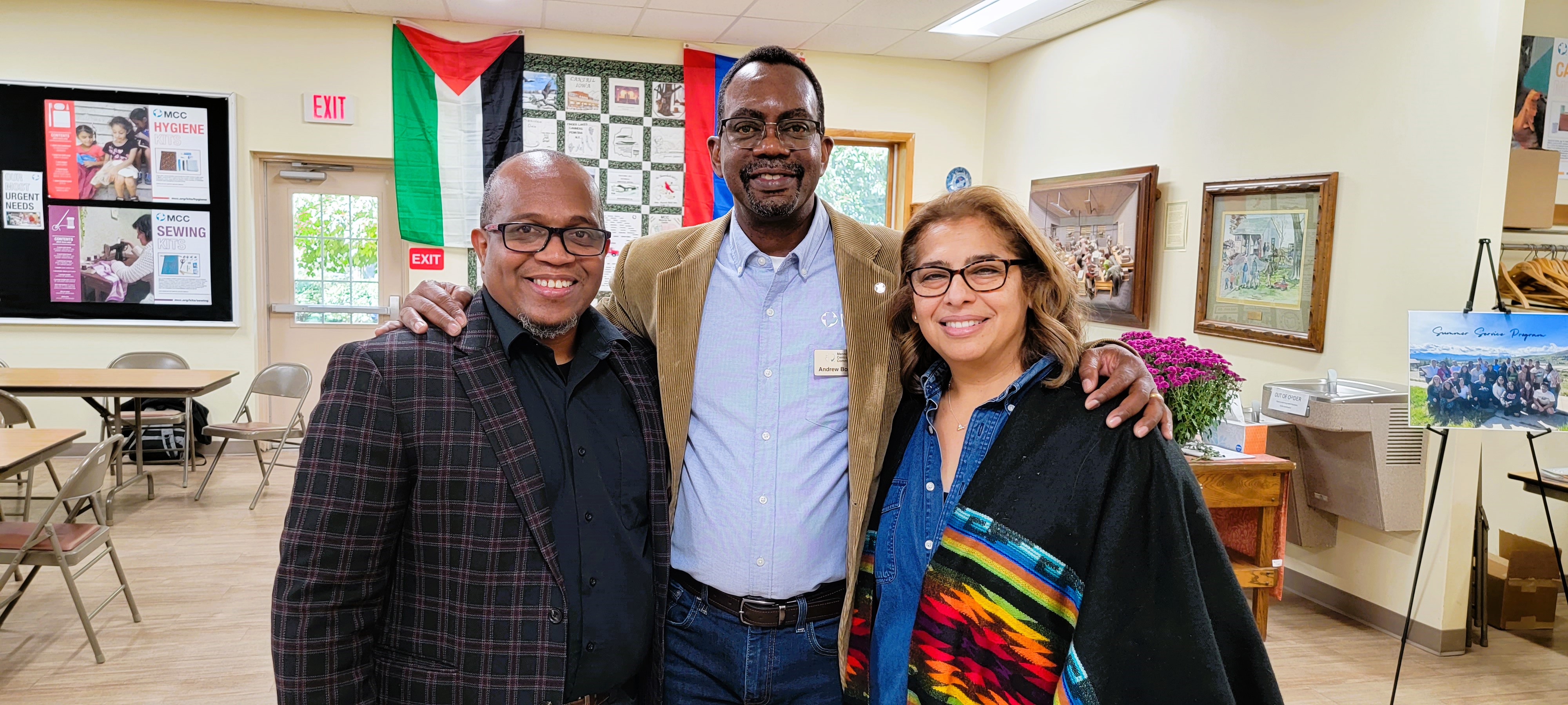 three latino people stand for a photo together