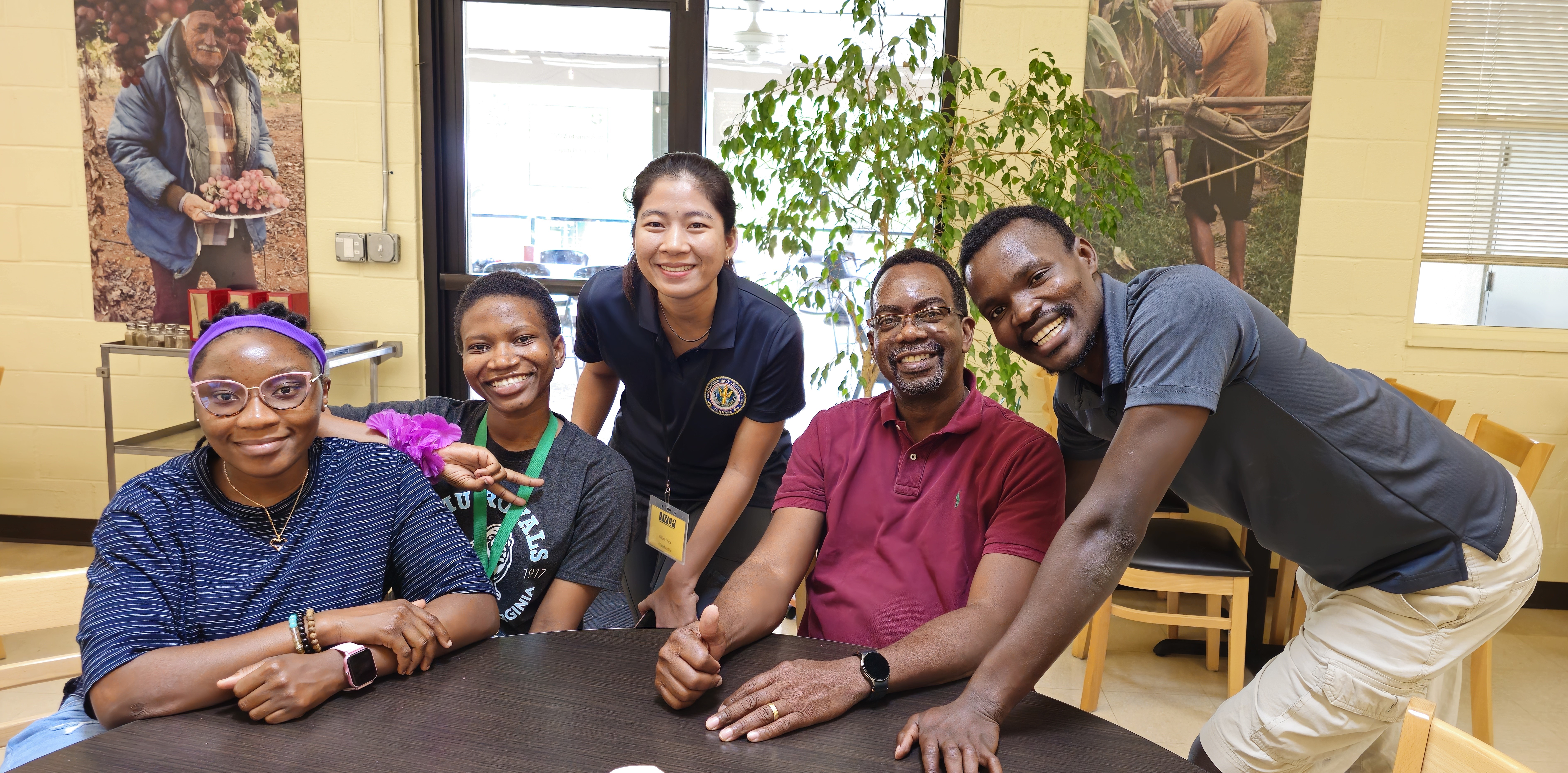 a group of people smiling together at a table