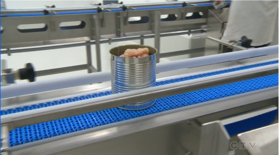 Footage from CTV shows a can of meat being moved on a conveyor belt at the MCC Cannery.