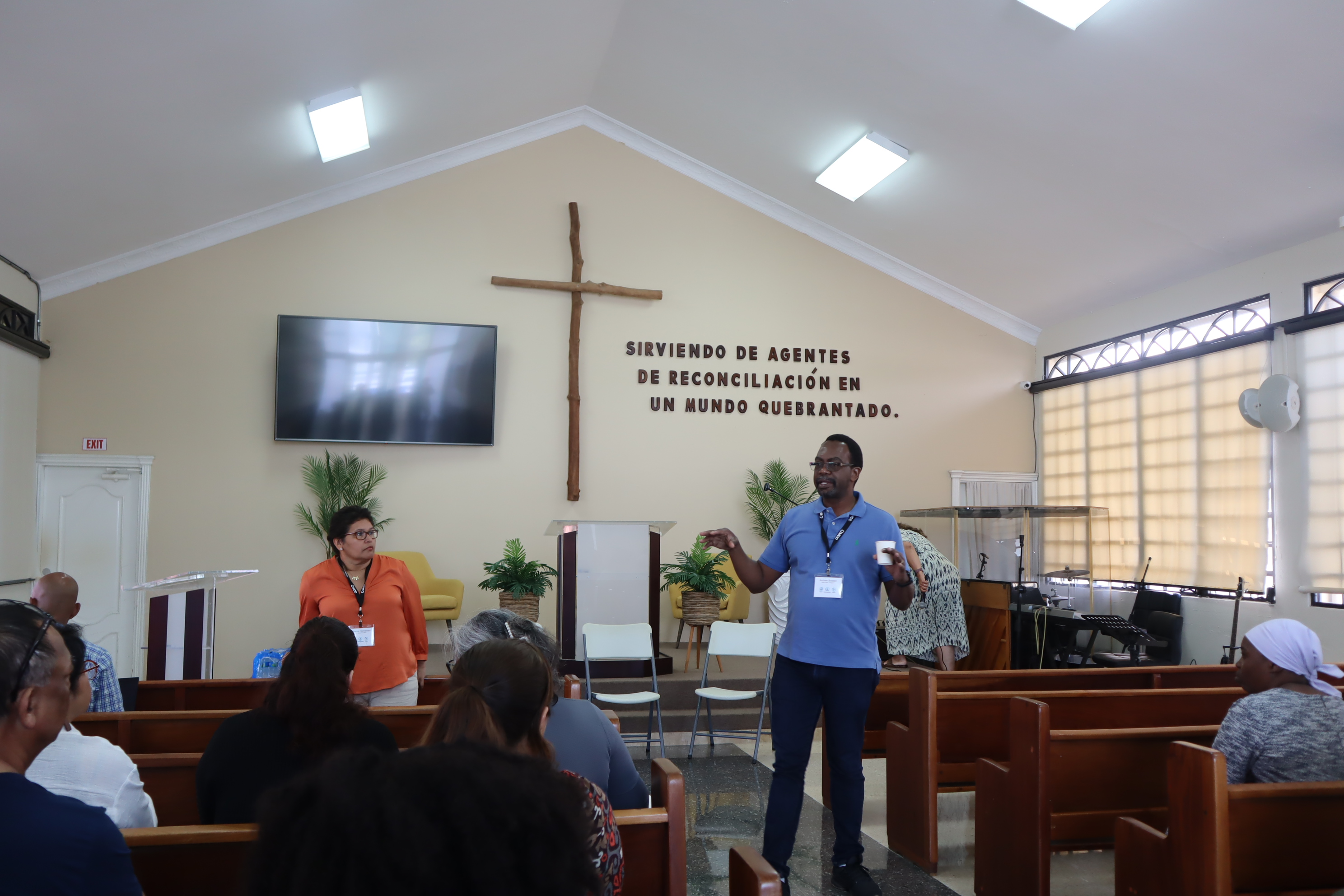 mcc staff speaks in a church to a group