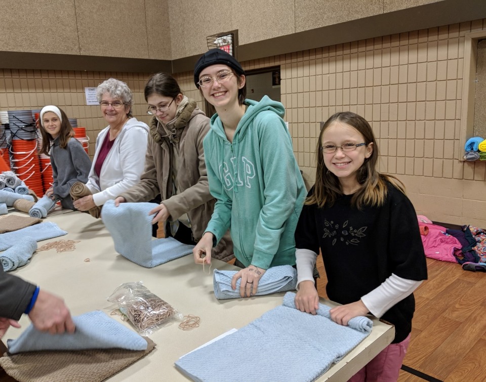 A group of people packing relief kits