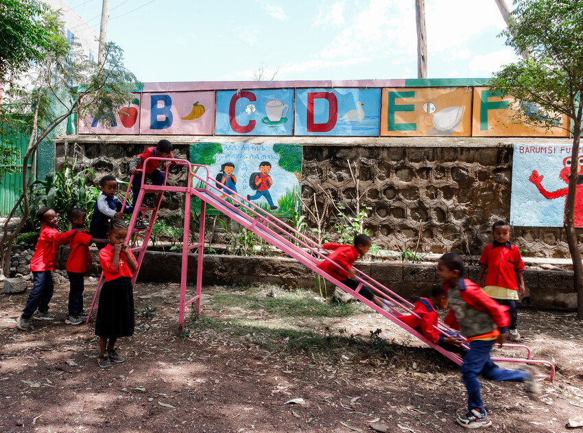 Children playing on a slide at a playground