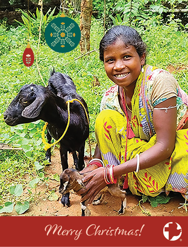 The cover of an MCC Christmas card featuring a young girl smiling next to a goat