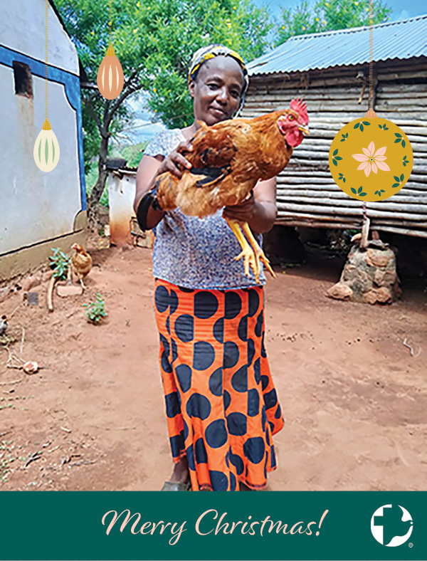 The cover of a MCC Christmas card featuring a woman holding up a chicken