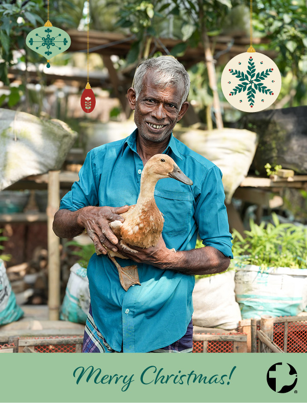 The cover of an MCC Christmas card featuring a man smiling holding a duck