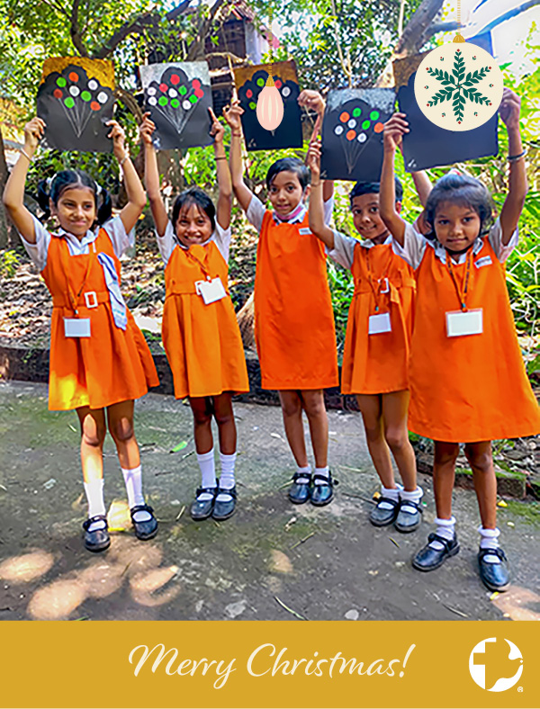 The cover of an MCC Christmas card featuring five young girls holding up artwork