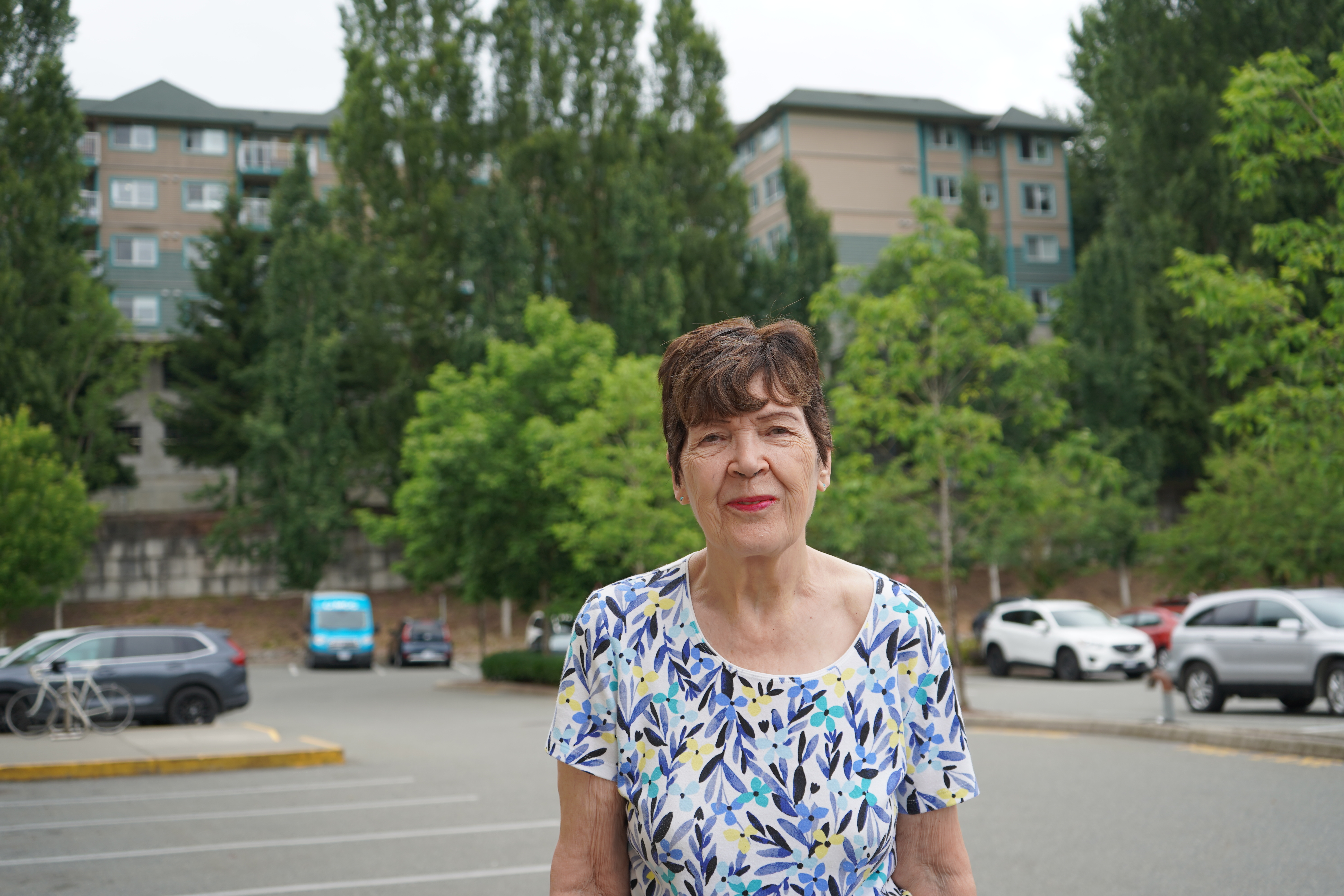 Linda Fraser stands outside in front of an apartment building, similar to the one she rents in Abbotsford, British Columbia
