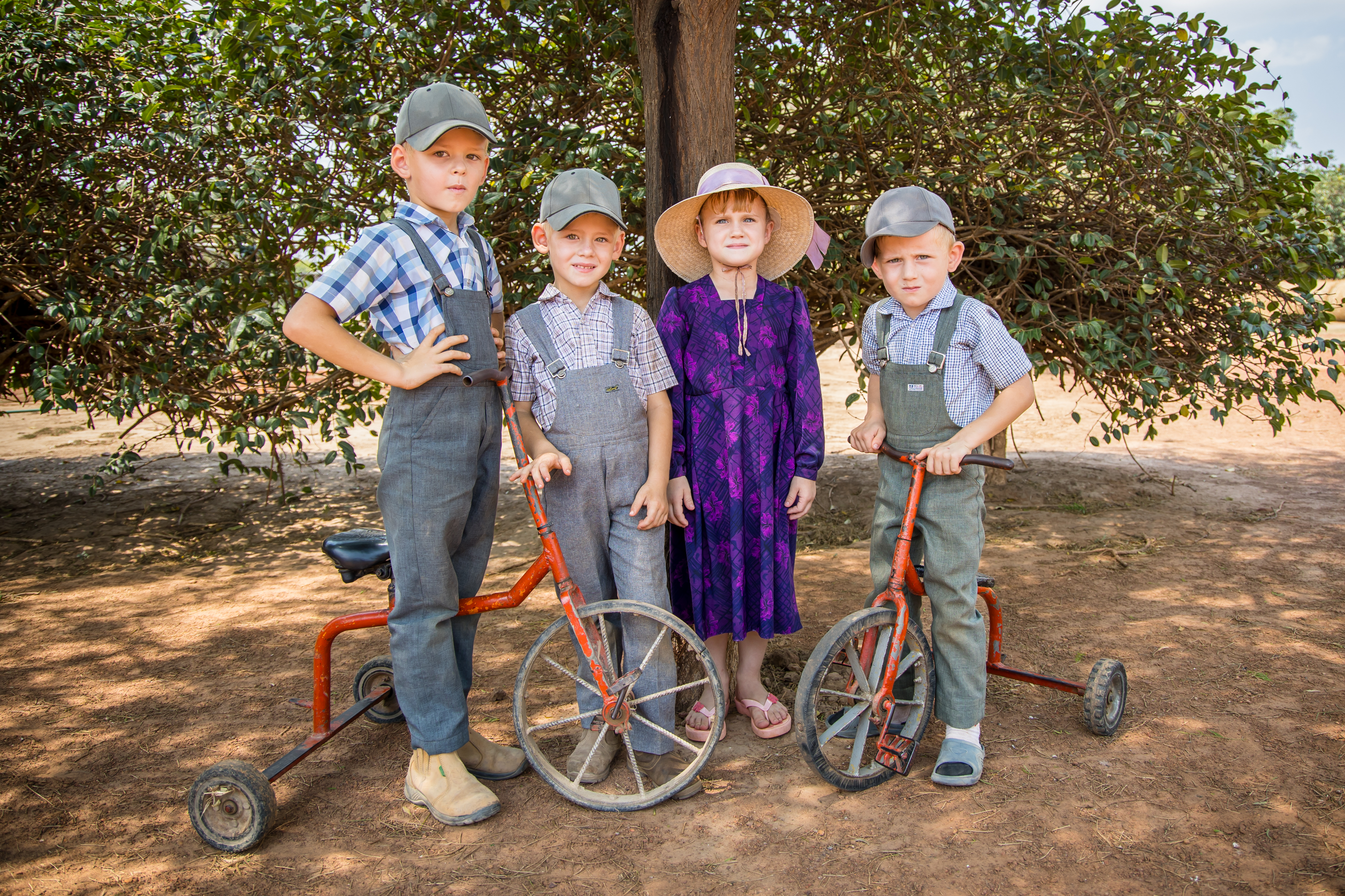 Group of children standing around a bike