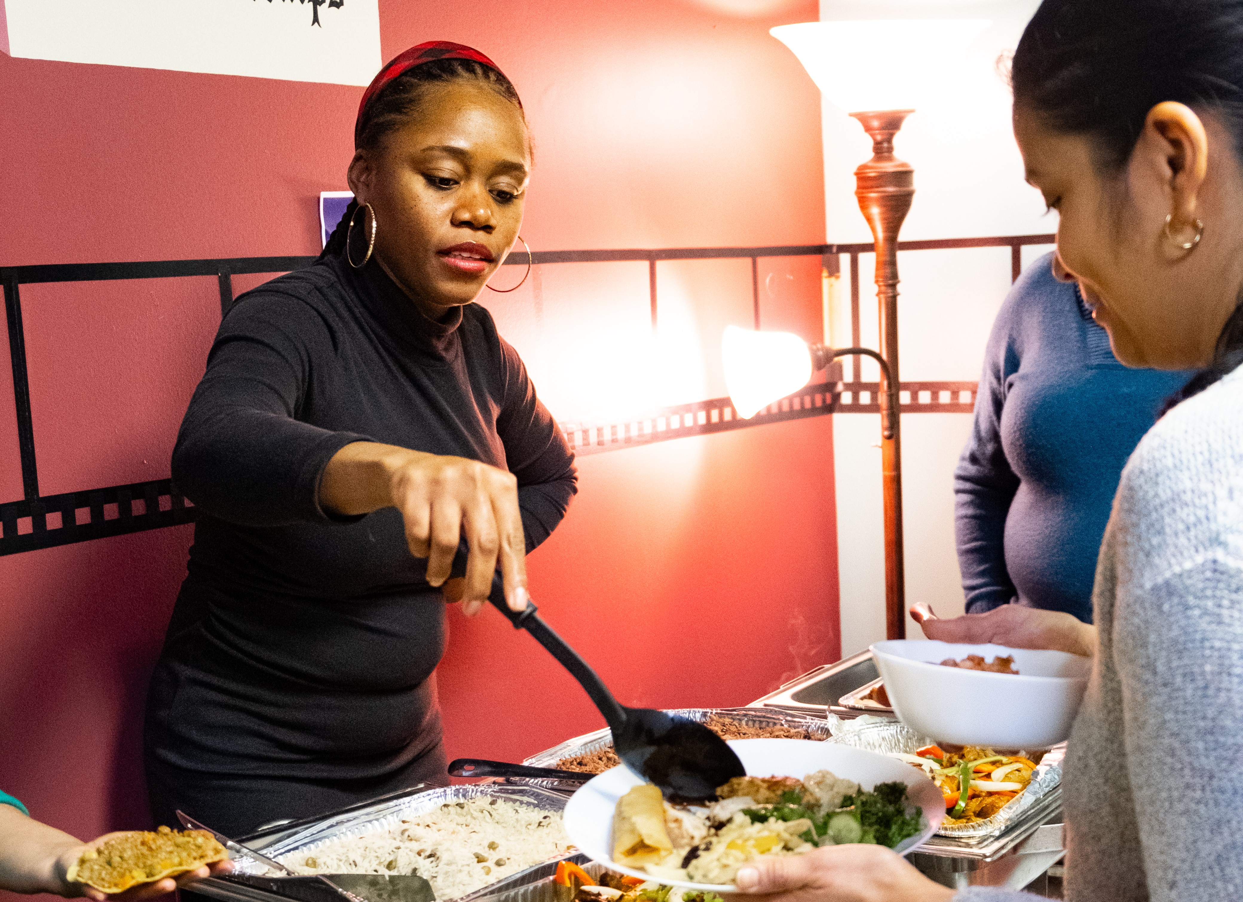Woman serves another woman at Souper Des Nations