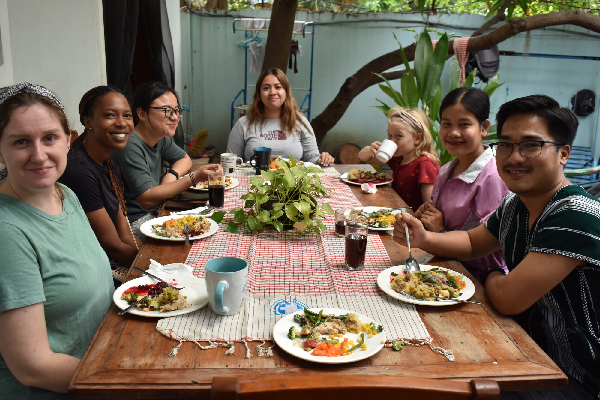 A group gathers around a table to eat