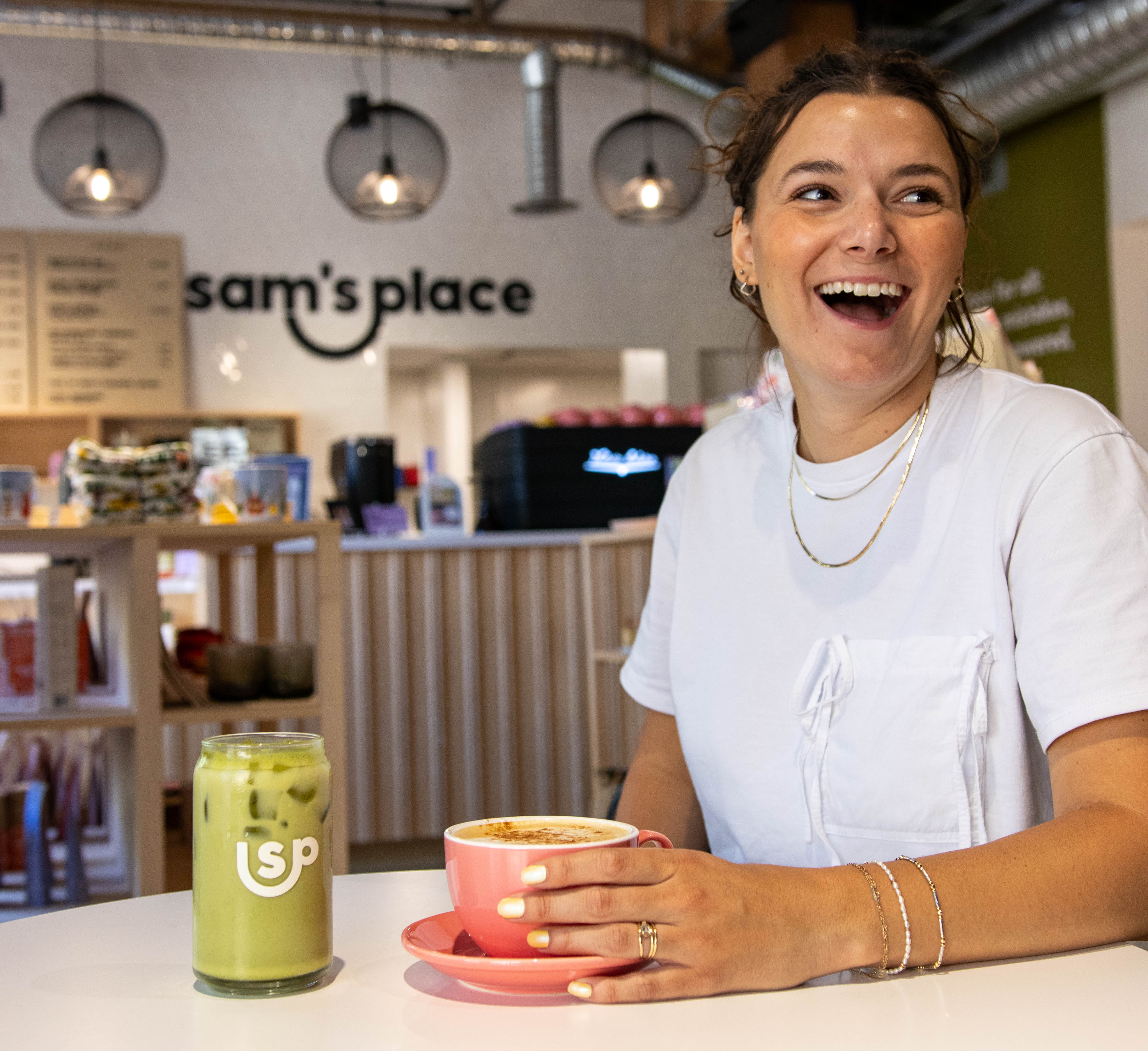 Rebecca Engel, Sam’s Place volunteer and youth program coordinator, holds a coffee cup