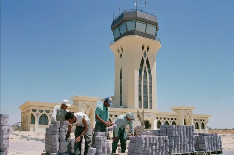 Workers gather cement bricks for constructing the Gaza International Airport in Rafah, 1997 (Abed Khateeb/AP Photo)