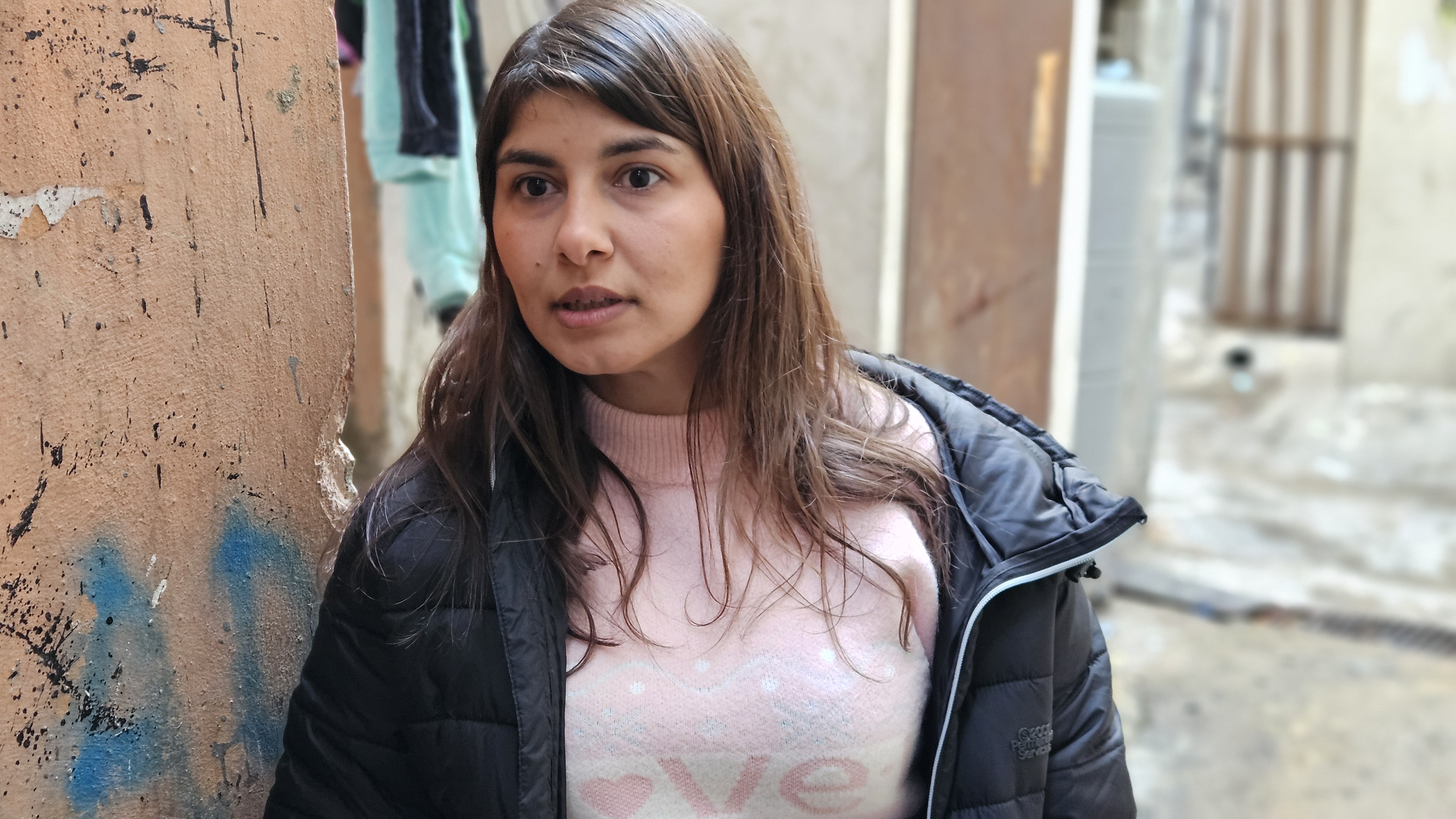 A field coordinator working with an MCC partner in Lebanon stands in an alley way. 