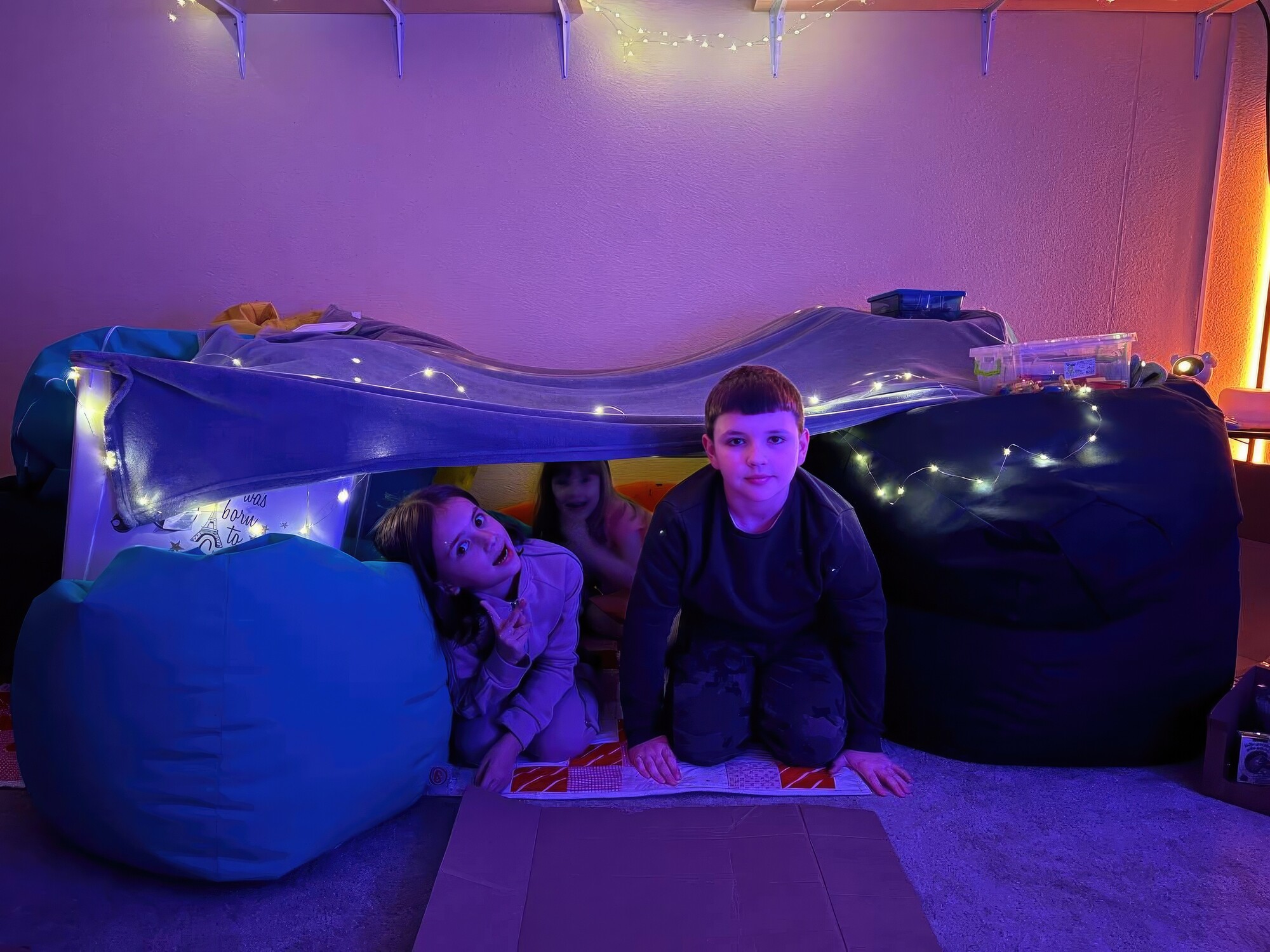 dark room with children crawling out of a tunnel
