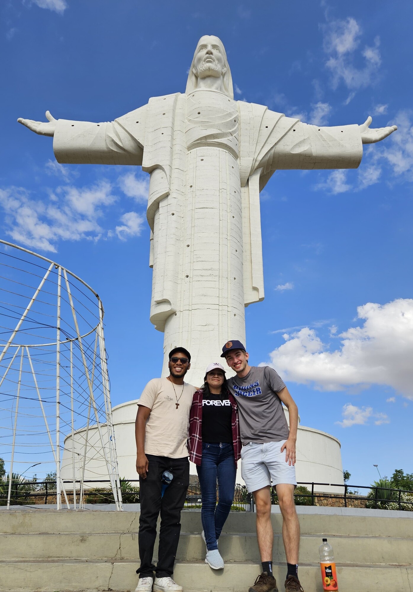 SALT* 2024-2025 participant Andrew Smucker (right, U.S. to Bolivia) and YAMENers (from left) Yuri de Araújo and Vilma Pop visit the 'Christ of Peace' monument near Cochabamba, Bolivia.