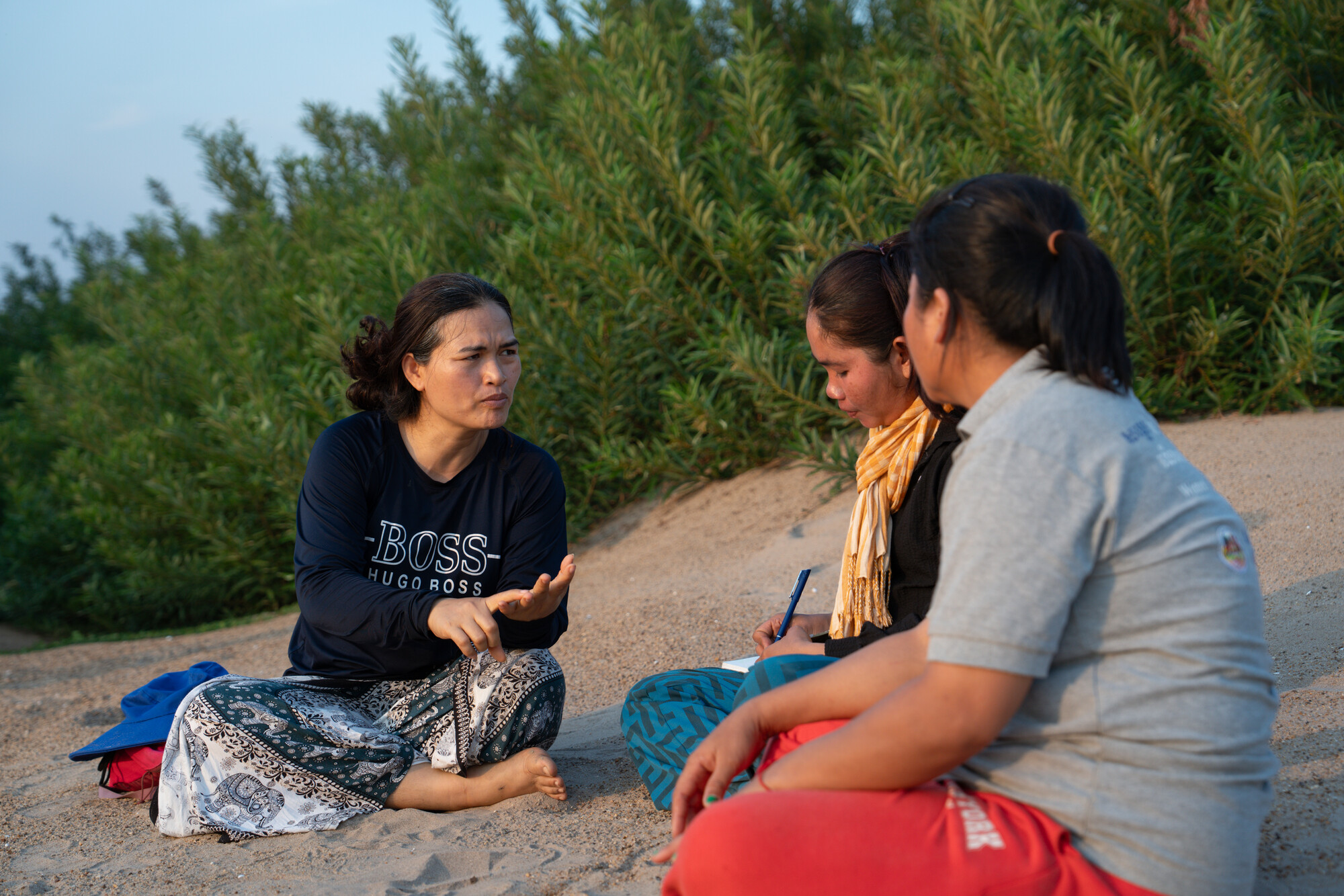 Left to right Koeut Chhunly, Theum Chan Thou, and Sor Navy share in a session led by Koeut Chhunly, Senior Program Coordinator of PBO during a river patrol