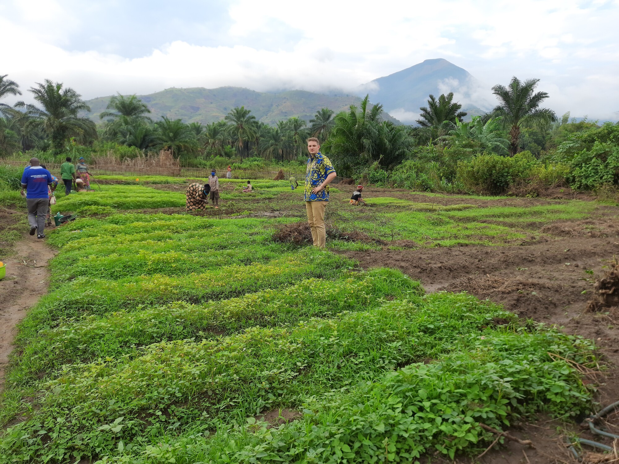 Jacob Yoder, representative for the Democratic Republic of the Congo, stands in a field during a visit to partner organization Oasis de la Culture in fall 2021.