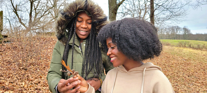 Josephine Kalondji, left, and Mwajuma Katembo admire an oak leaf while on a nature walk at Freedom Farm. 

Participants in the week-long "Peace for the weary" camp for young adults visited Freedom F