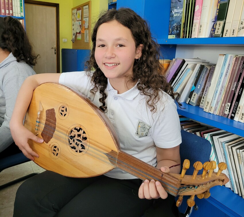 Sara Ghabbash is learning to play the oud (Palestinian guitar) in an after-school music program at Lajee Center in Aida Refugee Camp.