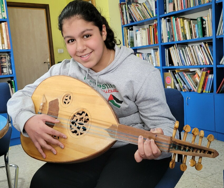 Jenan Ajarma, 13, is learning to play the oud (Palestinian guitar) in an after-school music program at Lajee Center in Aida Refugee Camp.