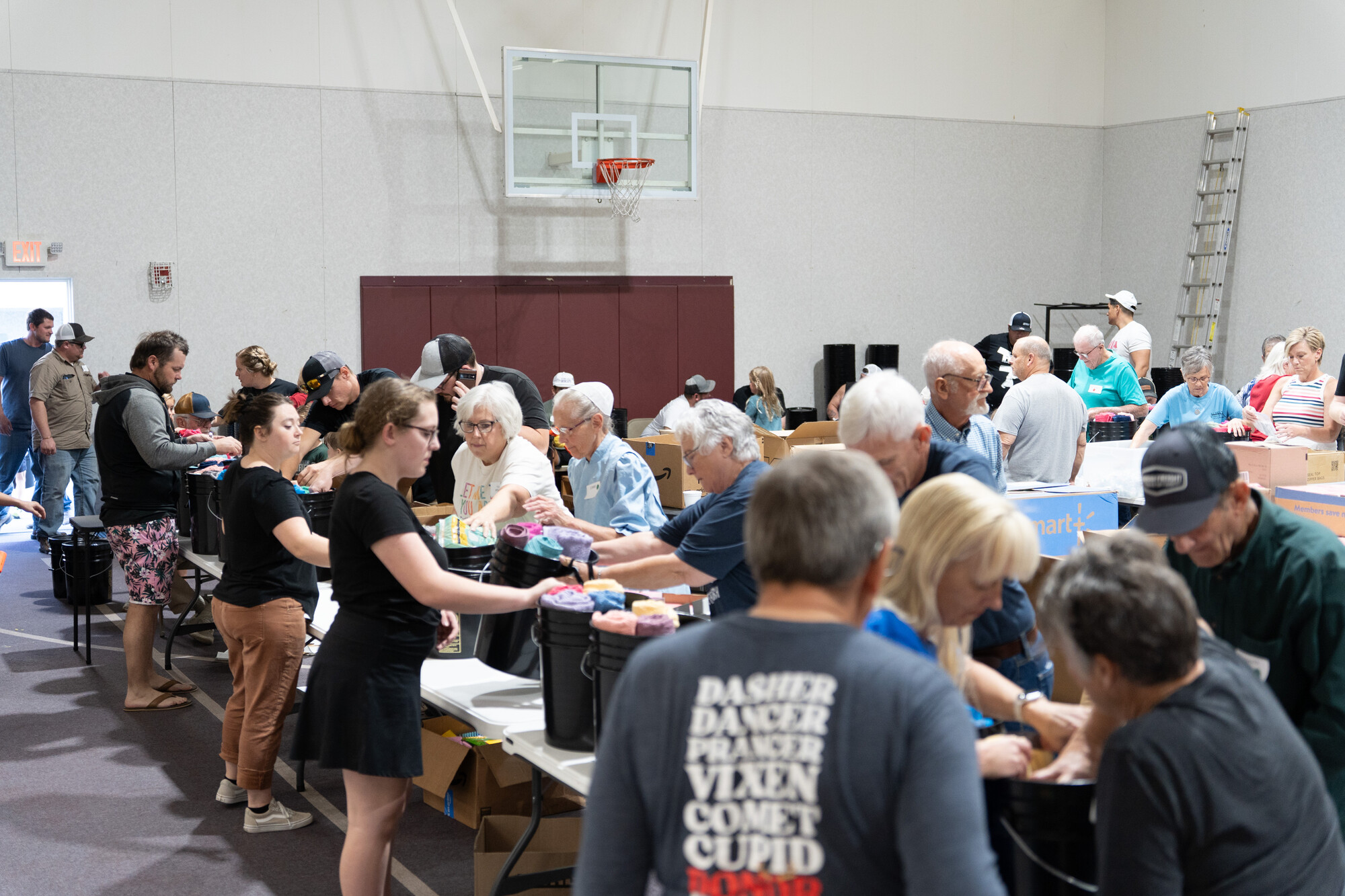 Volunteers pack hygiene items into MCC relief kits at Pleasant View Mennonite Church's annual relief kit packing event, which takes place in the church gymnasium.