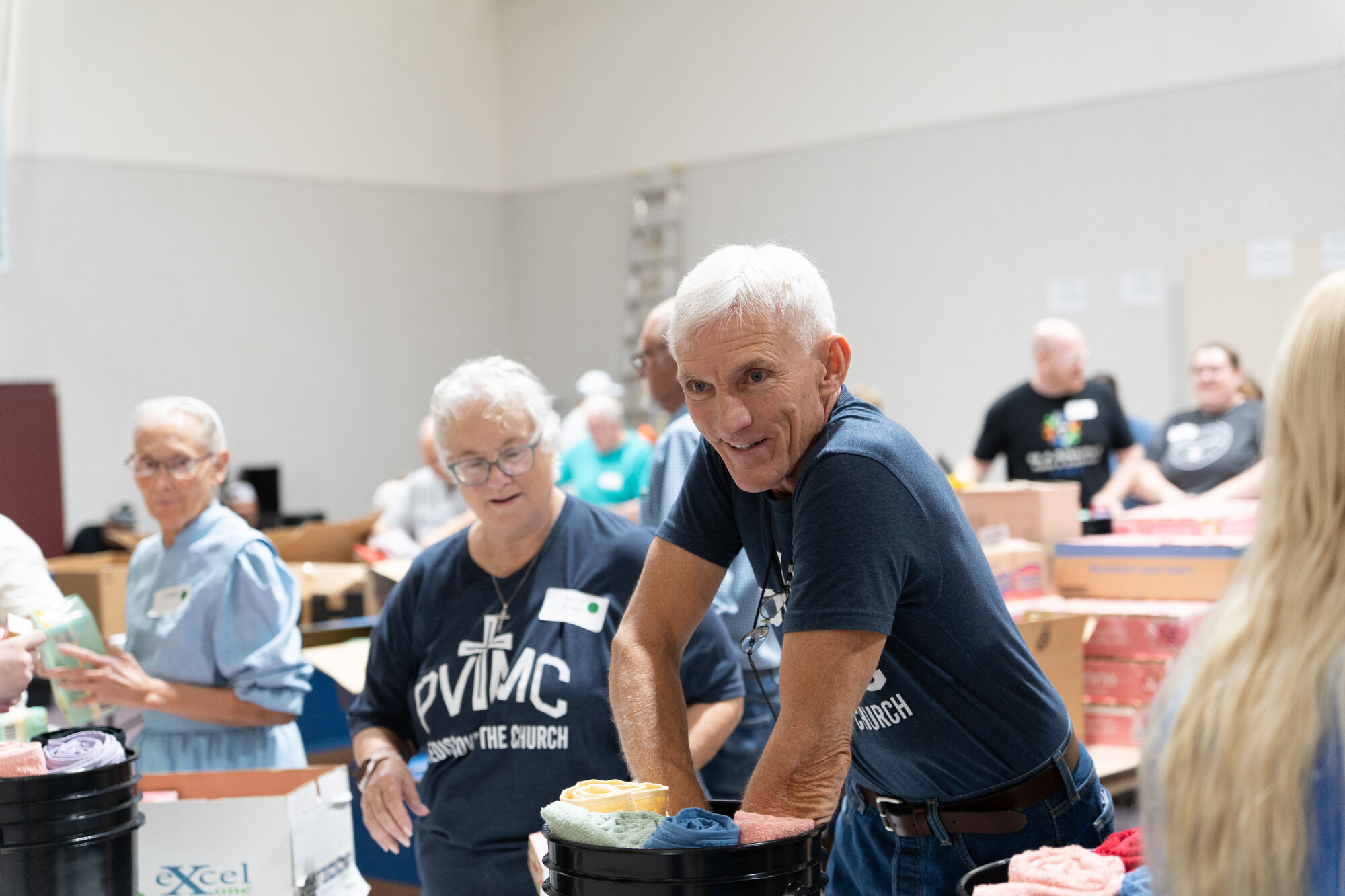 Sherry Corrigan and Michael Steigman pack relief kits at Pleasant View Mennonite Church's fourth annual relief kit packing event.
