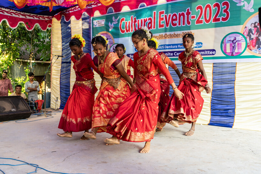 Young women from Santali and Mahali Indigenous groups perform a Mahali dance in a cultural program organized by MAASAUS.