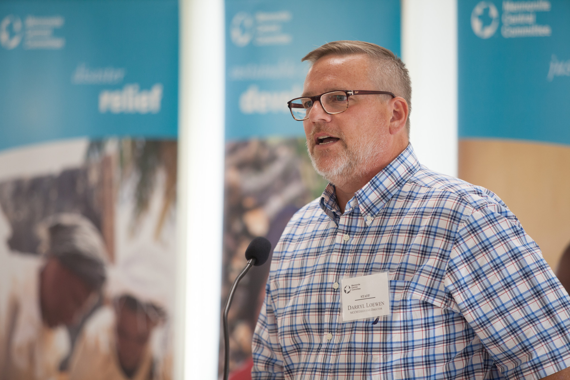 Darryl Loewen (MCCM Executive Director), addresses guests at the Grow Hope harvest celebration hosted by Crystal Spring Hutterite Colony. Grow Hope is an MCC project that brings farmers together with