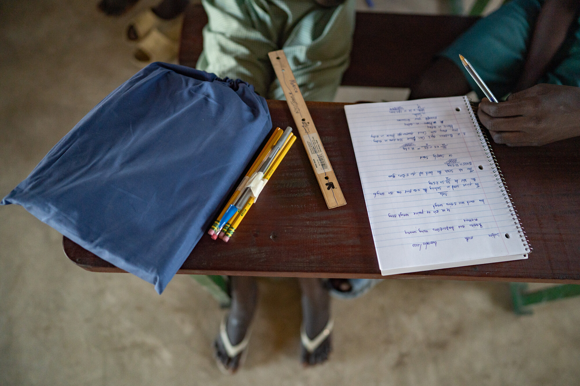 Contents of a school kit arrayed on a desk in a classroom at Saint Mary's Primary School.