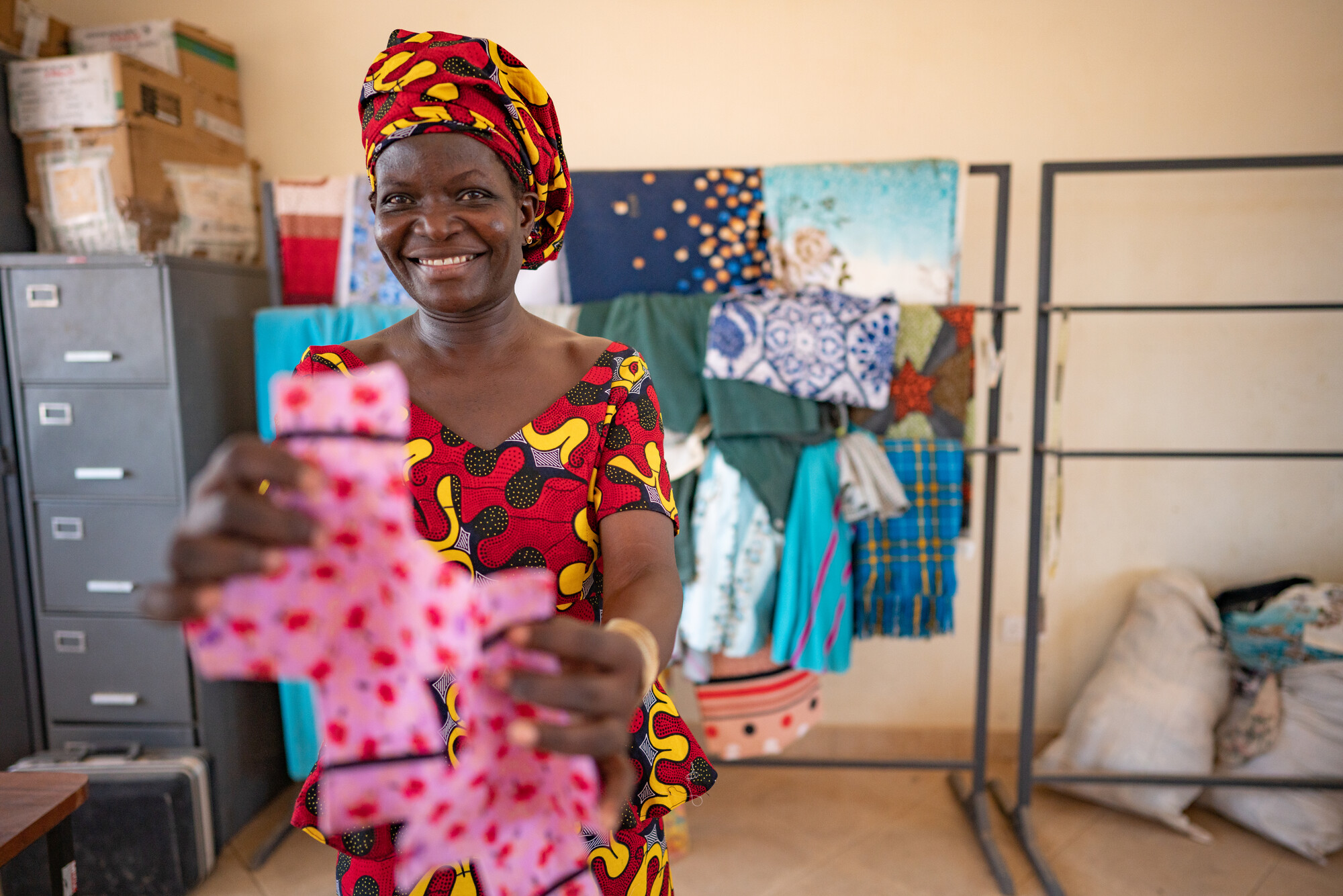 Millicent Teresa Otieno, 42, Loreto Rumbek School sewing instructor, holds an example of the reusable menstrual pad finished by the school dignity kit sewing project.