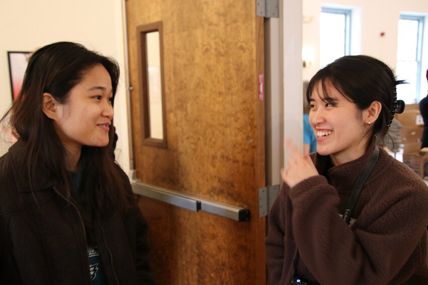 Esther Hong (left), an MCC International Volunteer Exchange Program (IVEP) participant from Cambodia, talks with Yujin Kim (right), Communications Associate for MCC East Coast, at the 2024 MCC East Co