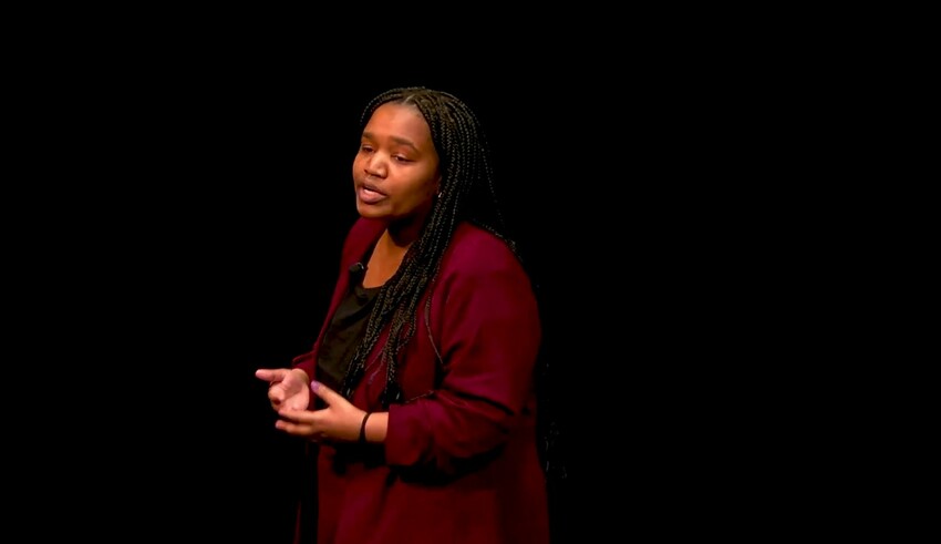 Video still of of Jakyra Green, senior at Goshen College, giving a speech at Goshen College. Green won first prize for her speech, "The privilege of peace," in the annual C. Henry Smith binational, in