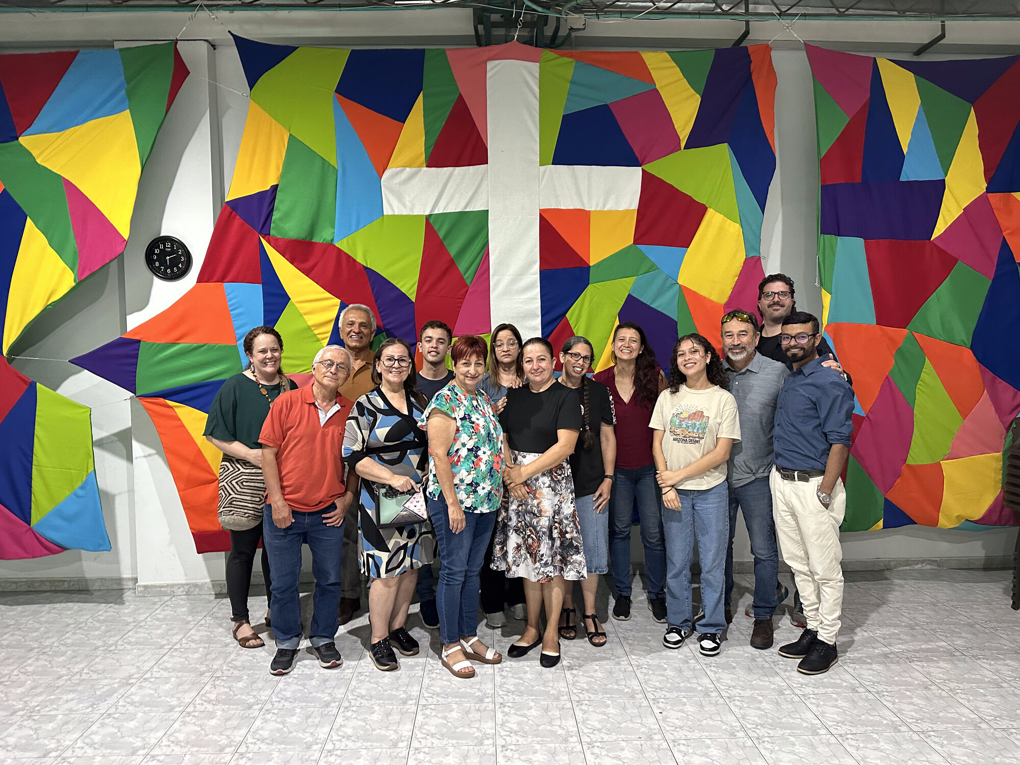 During an MCC East Coast learning tour in May 2024, Puerto Rican church leaders and pastors, MCC staff and members of Comunidad Cristiana Menonita de Paz in Armenia, Colombia gather for a group ph