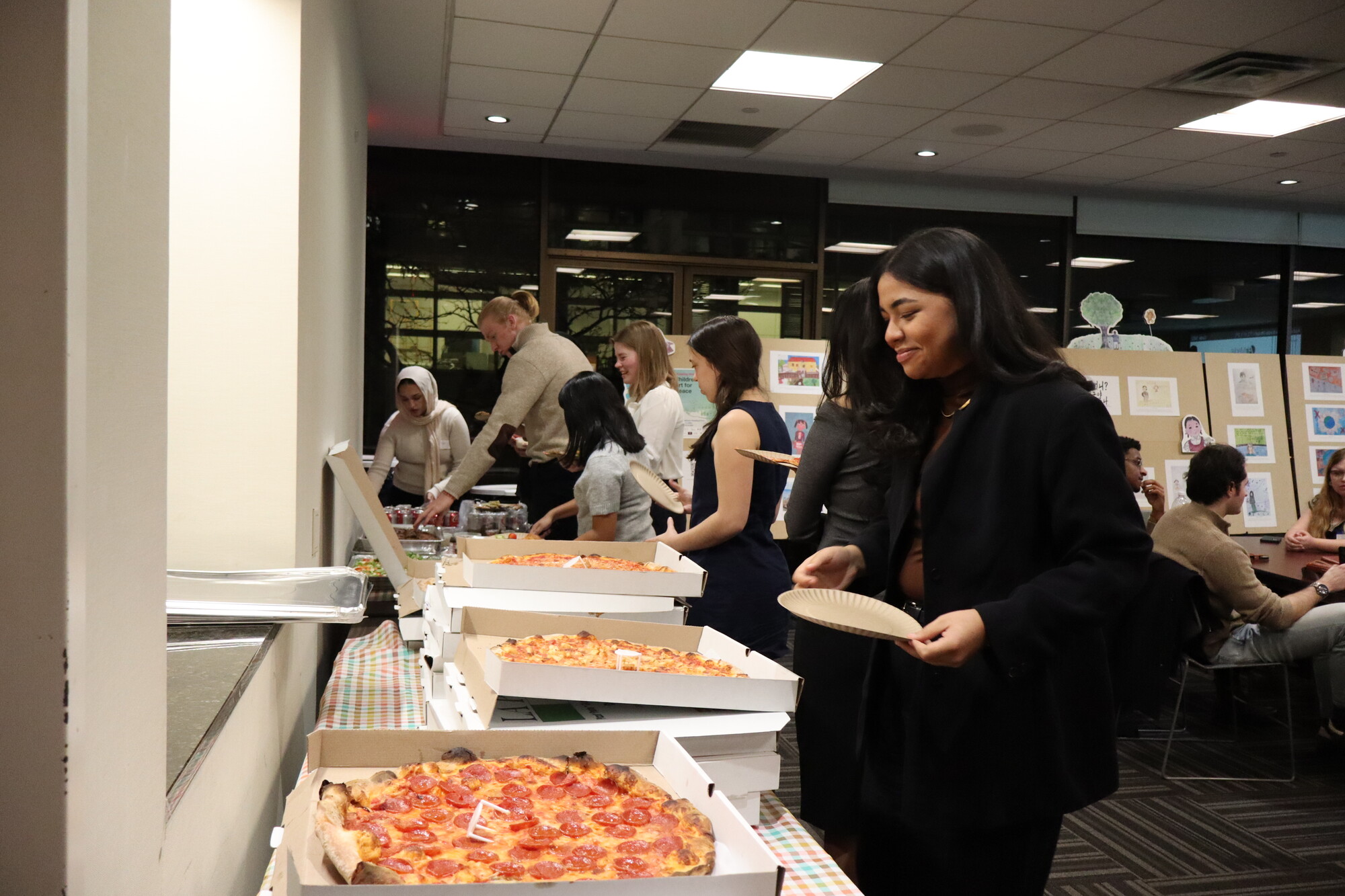 Livia Dias Moreira-Santos and other student participants enjoy New York style pizza for dinner at the UN Student Seminar in New York City in November 2025.