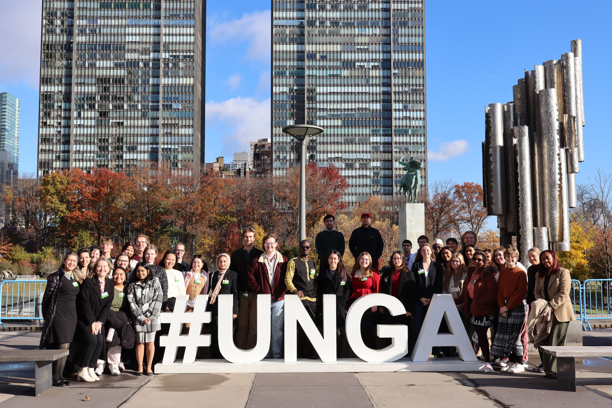 Participants pose in front of a sign at the United Nations Headquarters during the MCC UN Student Seminar in New York City in November 2025.