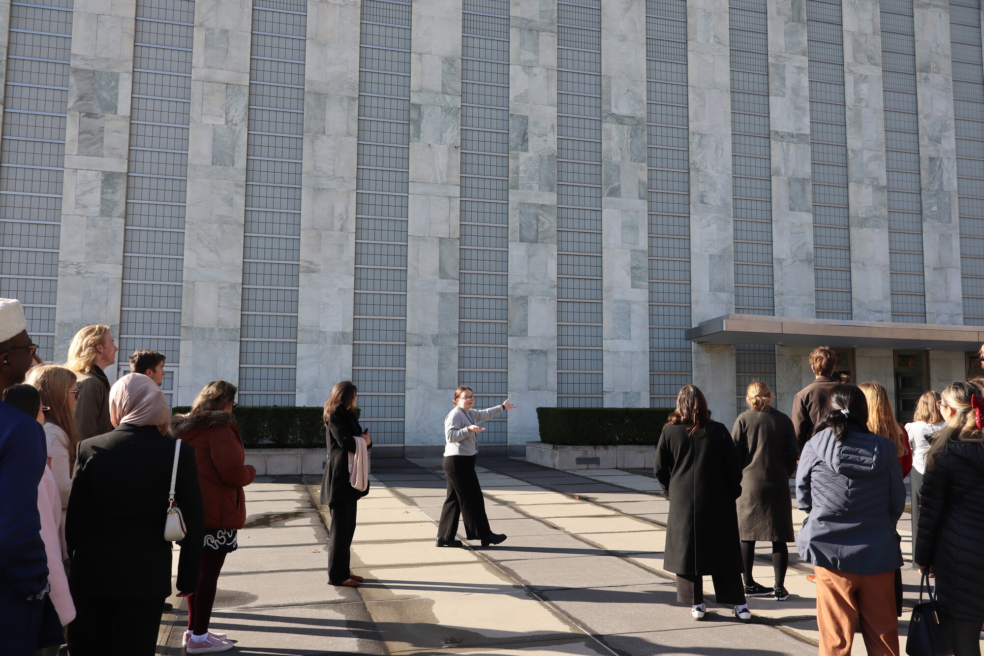 Victoria Alexander, MCC UN Advocacy Coordinator, leads participants into the UN building for the guided tour during the MCC UN Student Seminar in New York City in November 2025.