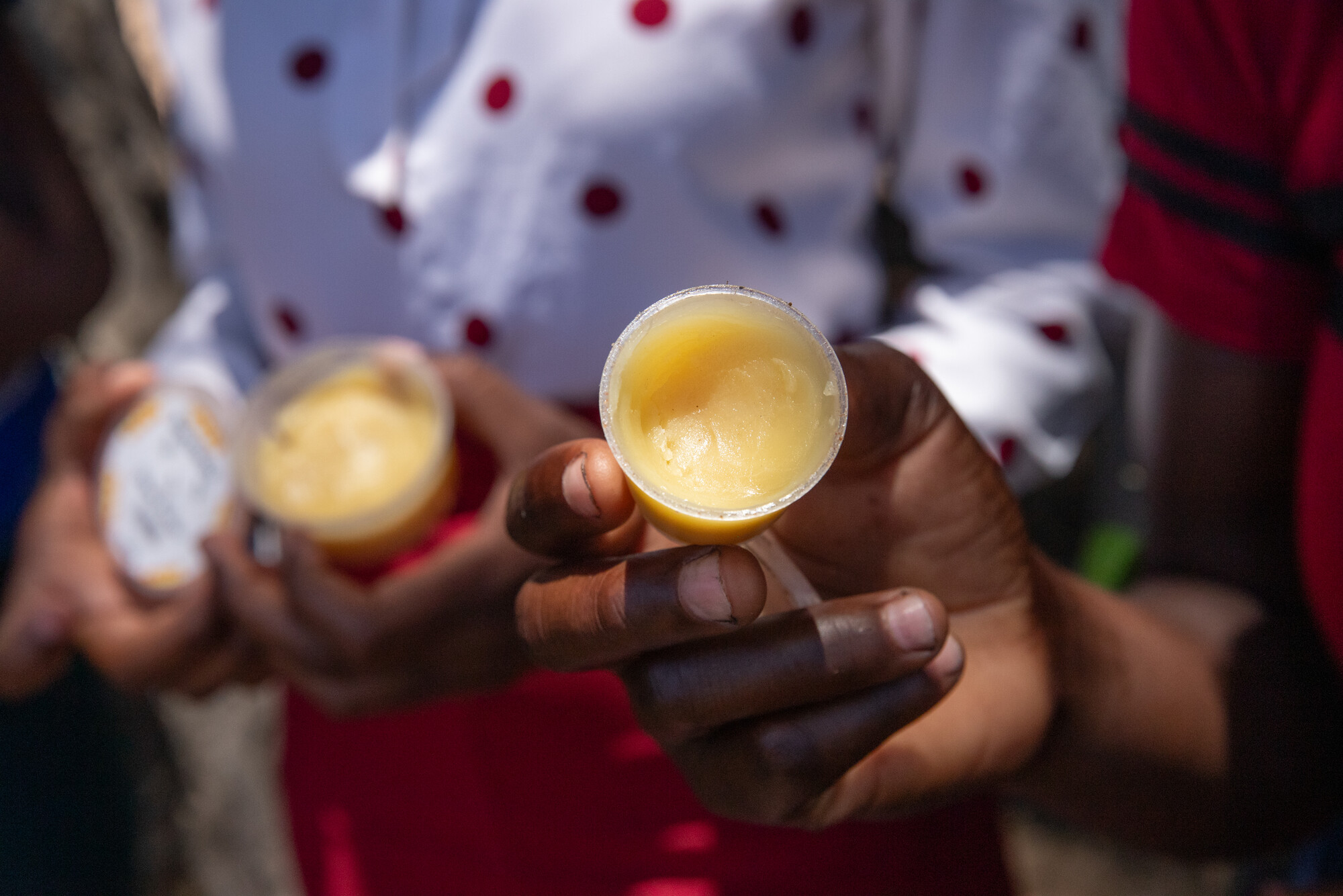 Members of the youth beekeepers’ group in Samende village hold products they’ve made from beeswax.