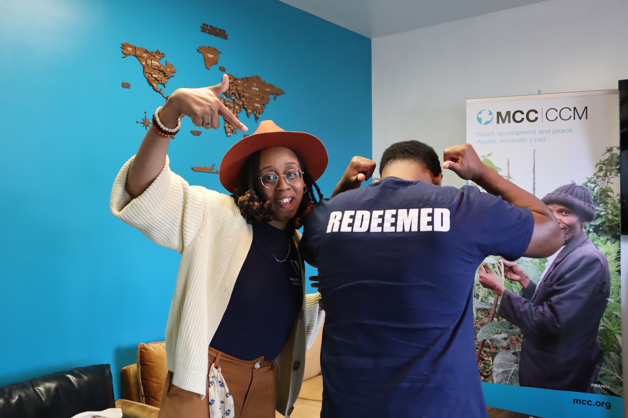 Dr. Lori Banfield, Executive Director of Redemption Housing, playfully points at Jonathan McClendon, Chaplain Intern at Redemption Housing, who is wearing a shirt with the word “REDEEMED,” in Phil