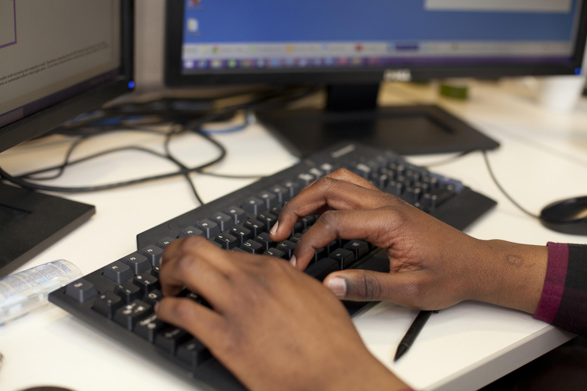 Goodwill Gwala types at his computer station, providing remote IT support to an MCC user. Orginally from Pietermaritzburg, South Africa, Goodwill is working with MCC Canada's IT department as an Assi