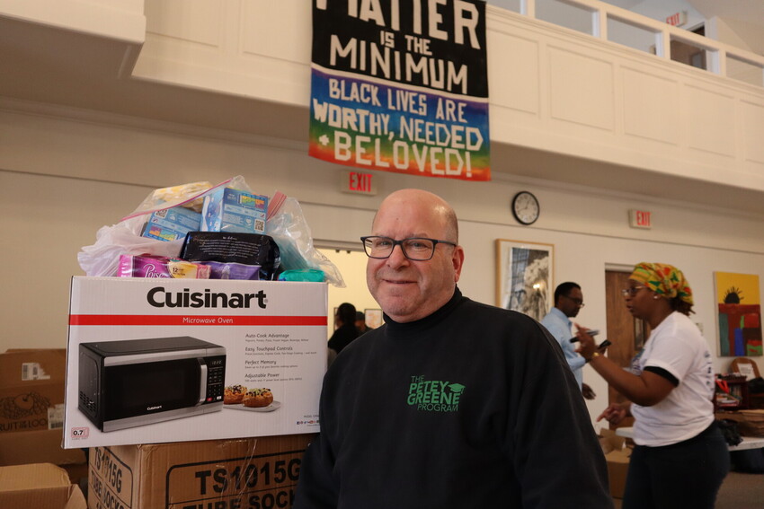 Jeffrey Abramowitz, chief executive officer of the Petey Green Program and Philadelphia resident, poses for a photograph with feminine hygiene products that will be used in MCC’s prison care kits fo