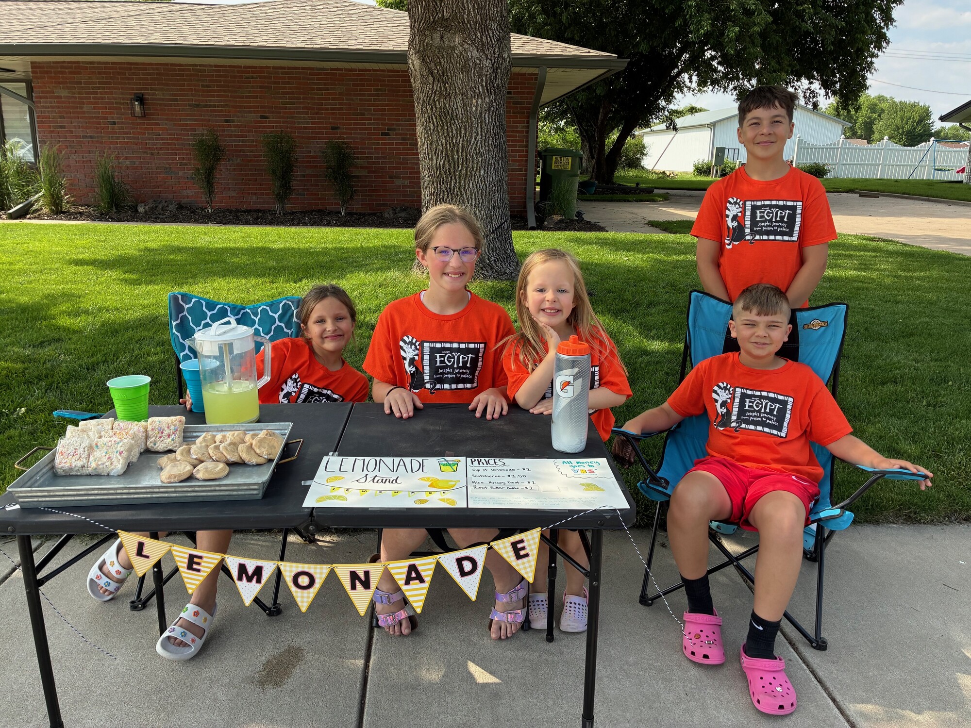 Pastor Andrea Wall’s children, and their cousins, raise funds for food baskets at their lemonade stand.