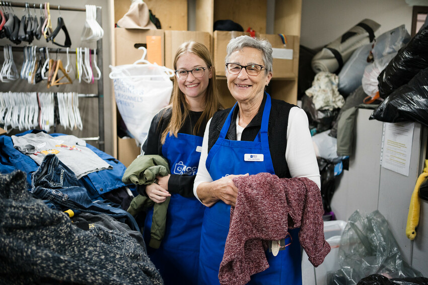 Amy Peters (left) and Darlene Rempel (Right) take a short break sorting through clothing donations at the Taber MCC Thrift Shop to pose for the camera.