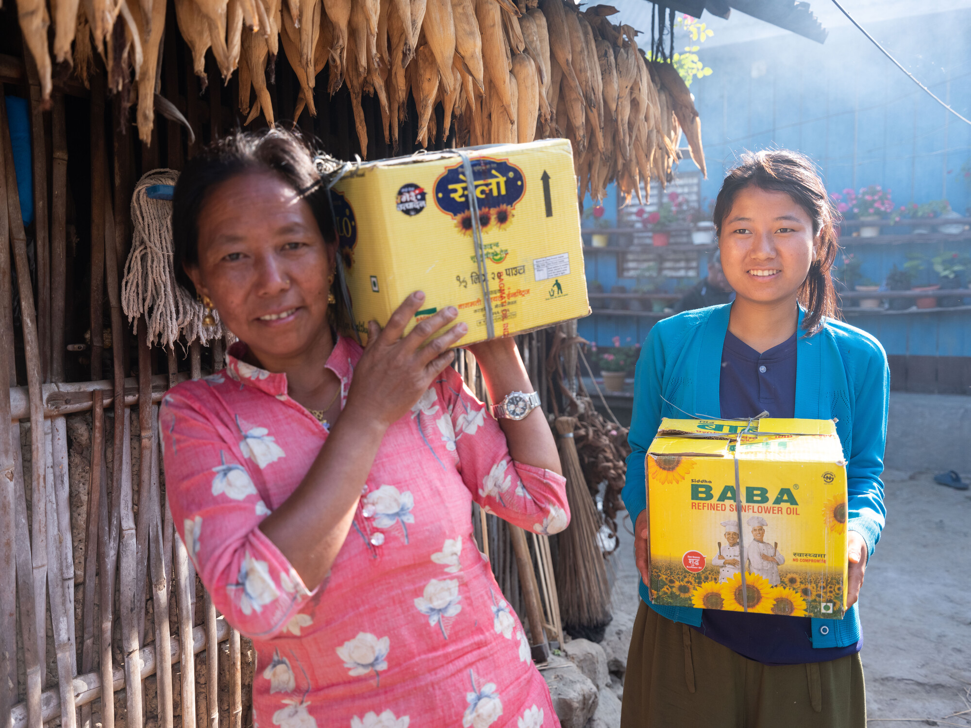 Puja Majar (21) and her mother, Purna Kumari Magar, are carrying strawberry packets to deliver to the market in Kerabari Rural Municipality-3 in Morang, Nepal on Sunday, April 21, 2024.