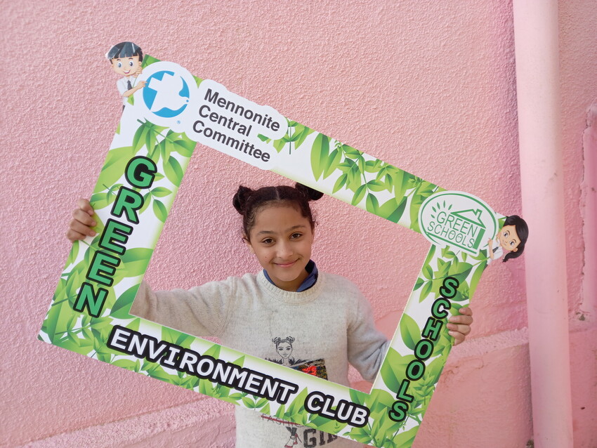 Nour Mohamad is a student member of the Environment Club established at Natel Comprehensive Secondary School for Girls under the Green Schools project. She celebrates the project's success and poses i