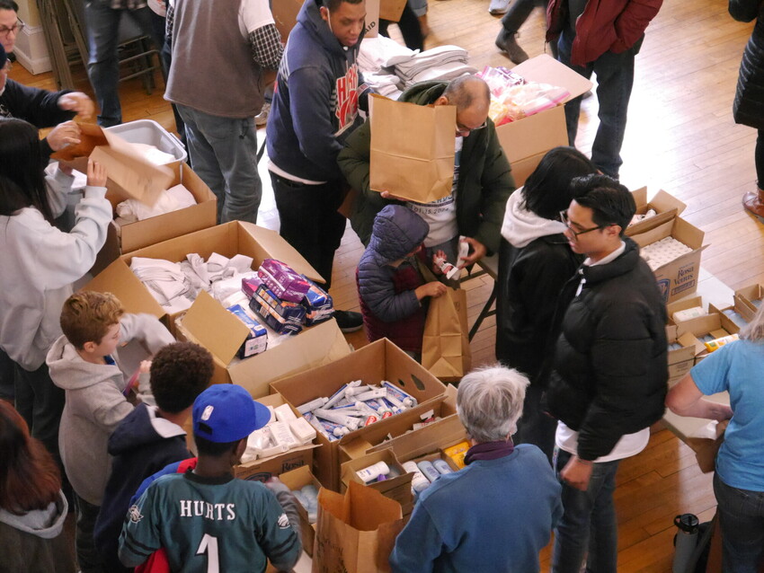 Youth and adults from the Philadelphia community pack MCC prison care kits at MCC’s MLK service day event in Philadelphia in January 2024.