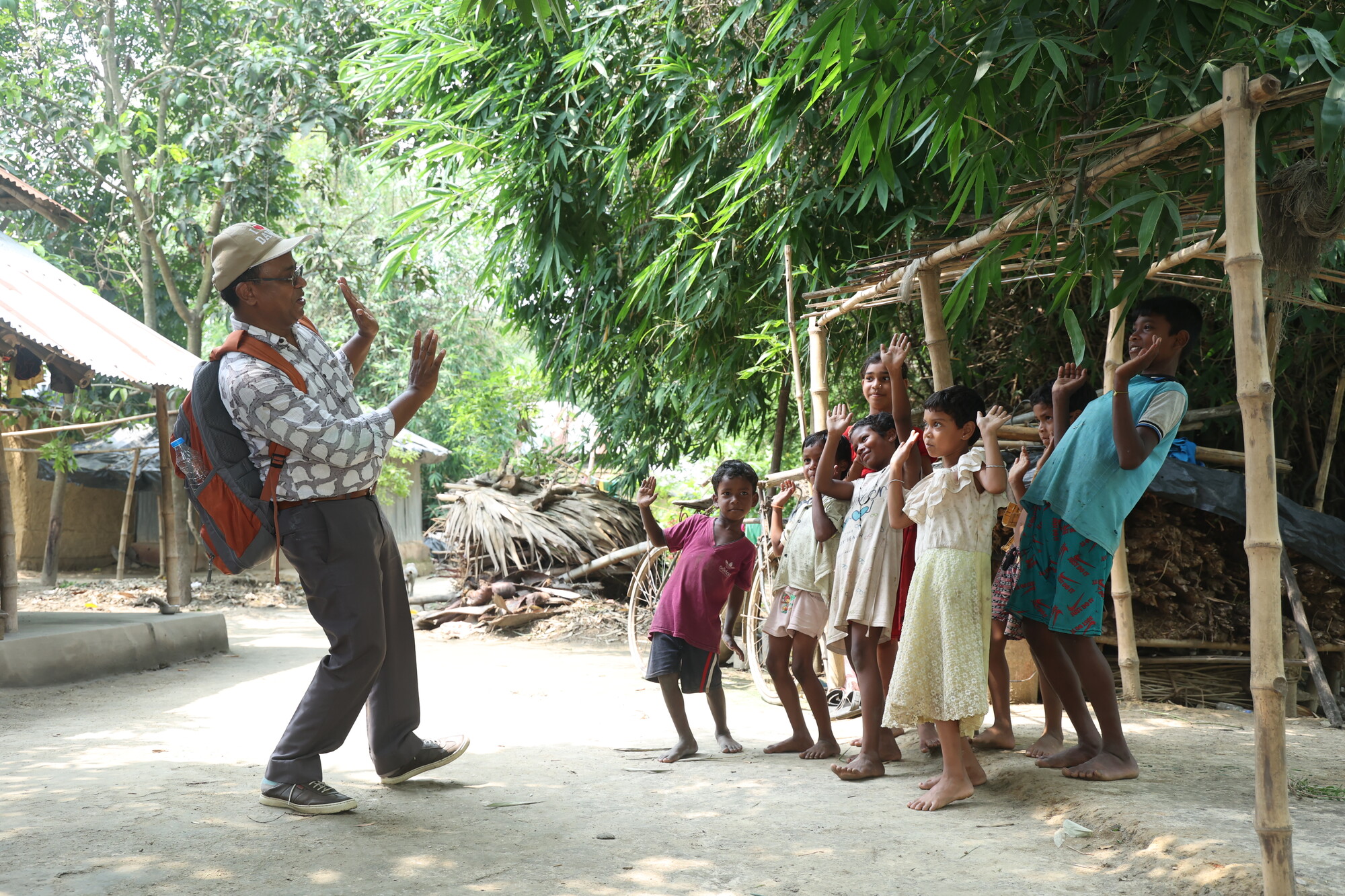 Madhur Lakra, MCC project officer forMCC, leads a group of children in the village of Ruhimari in an action song that promoted healthy WASH practices.&nbsp;