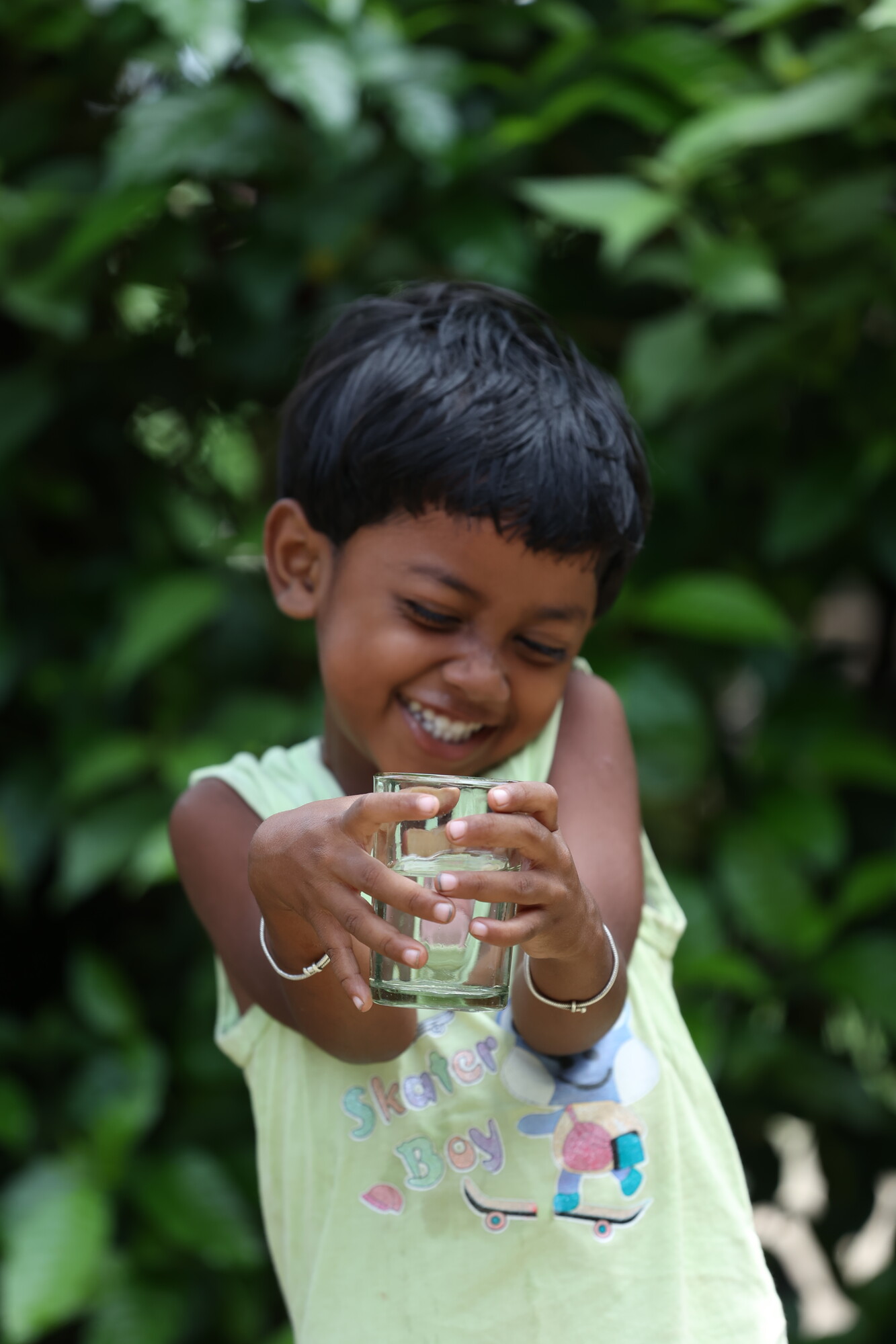 Alexa Chick Baraik, a 5-year-old girl who lives in the Kohinoor Tea Garden community, enjoys a glass of filtered water.