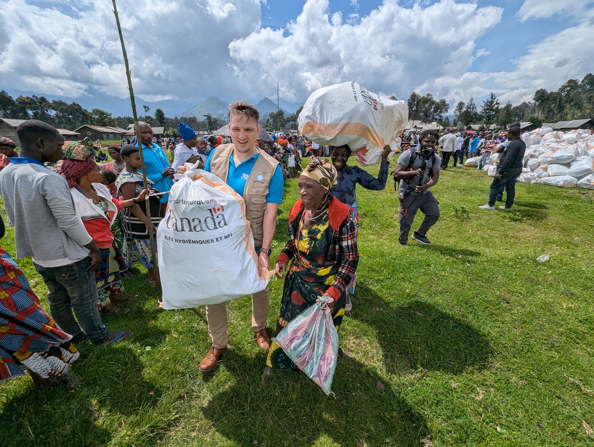 During a distribution event in Kibumba, North Kivu, in the Democratic Republic of the Congo, MCC representative Jacob Yoder shares a moment of joy with Mukandagara Daphrose, who received essential ite